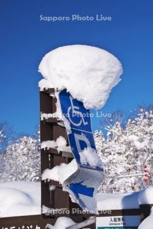 旭岳ビジターセンターの駐車場案内板に積もった雪