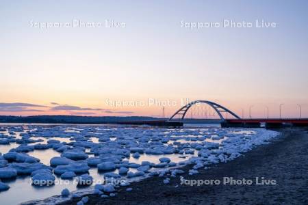 朝焼けの温根沼大橋と流氷
